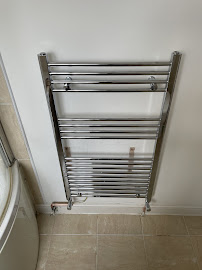 Chrome heated towel rail installed by Wright Plumbing and Heating